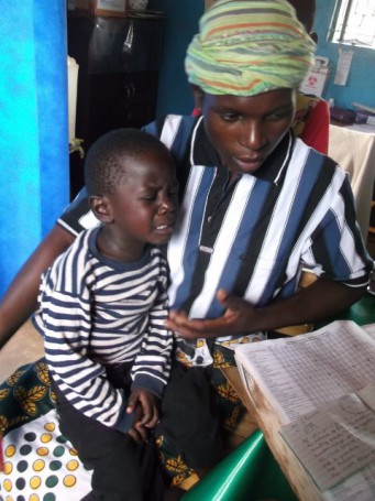 This little boy is feeling very poorly, he is suffering from Malaria